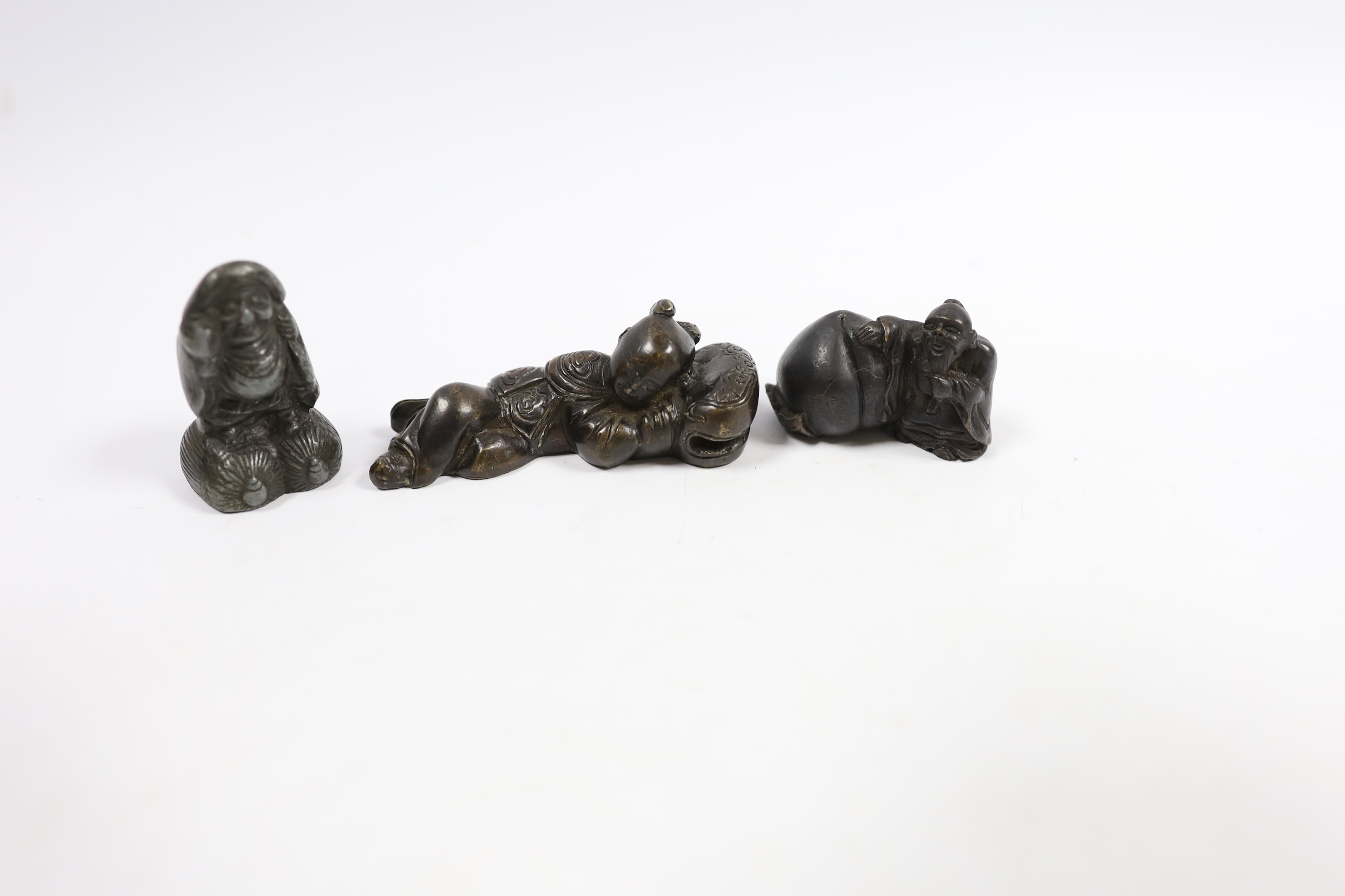 Two 19th century Japanese bronze scroll weights and an antimony figure, largest 7cm